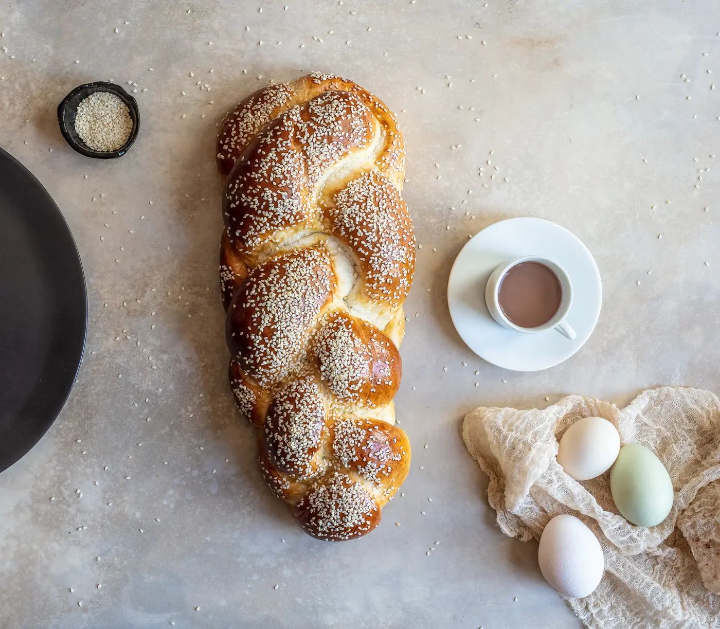 A Friday challah, braided and scattered with sesame.