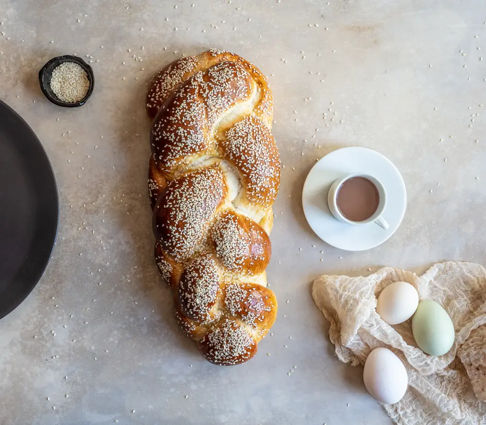 Braided sesame challah viewed from above.